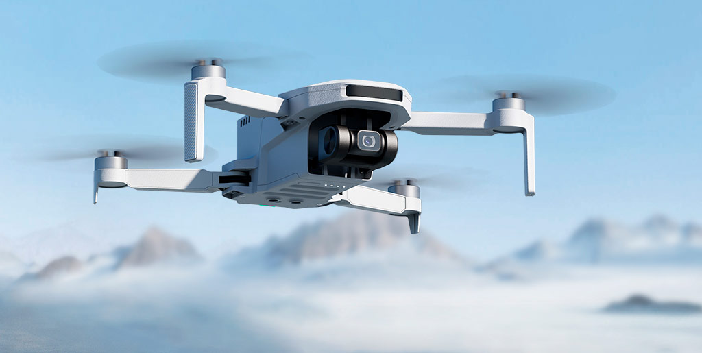 Mini dron Potensic Atom SE en vuelo, viendo su parte lateral, inferior y frontal, con unos picos de fondo que sobresalen de las nubes bajo un cielo azul